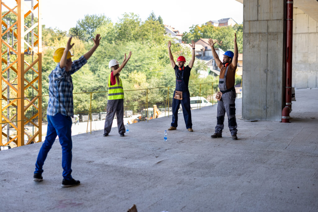 A Group of Multicultural Workers are Exercising During a Work and Stretching a Muscles.
