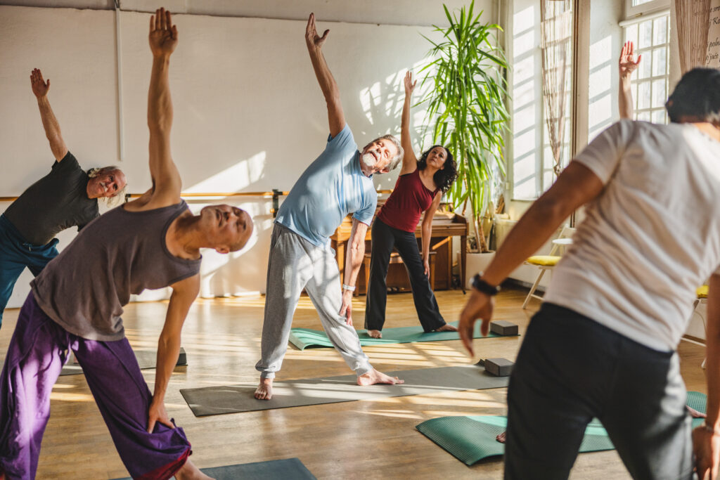 Group Of Multicultural Yoga Students Observing And Practicing During Class